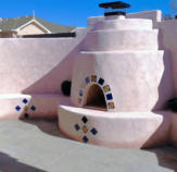 Pink stucco Kiva Fireplace by Mountain Paradise Landscaping, Rio Rancho & Albuquerque, New Mexico