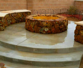 Wood burning fire pit made with moss rock and benches by Mountain Paradise Landscaping, Rio Rancho & Albuquerque, New Mexico