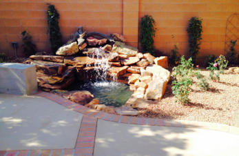 Moss rock waterfall and pond landscaping water feature by Mountain Paradise Landscaping, Rio Rancho & Albuquerque, New Mexico